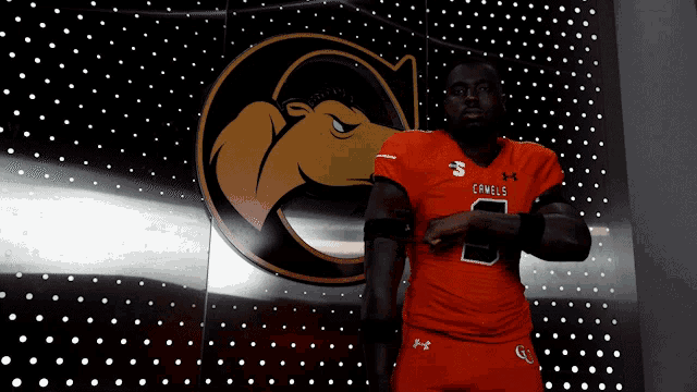 a man wearing an orange jersey with the number 8 on it