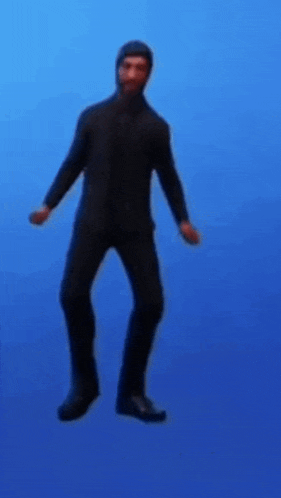 a man in a black suit and hood is dancing on a blue background .