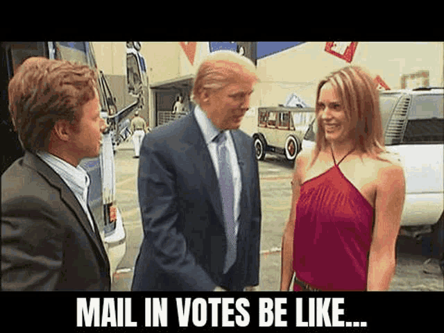 a man in a suit and tie is shaking hands with a woman in a red dress .