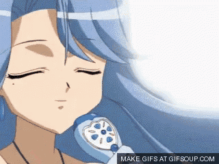 a gif of a girl with blue hair holding a phone with the words make gifs at gifsoup.com below her