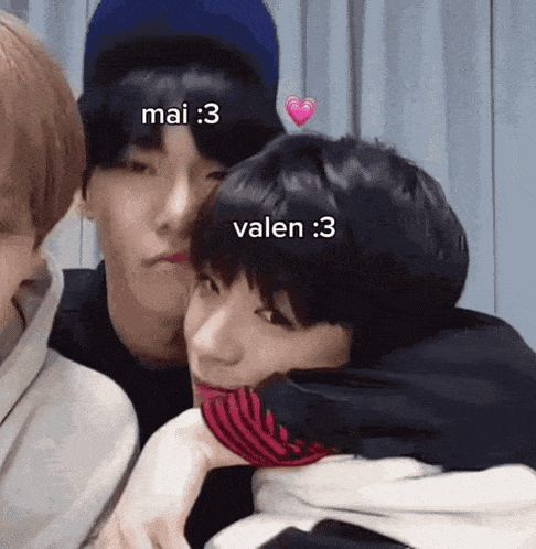 a group of young men are hugging each other and one of them has a heart on his forehead that says mai 3