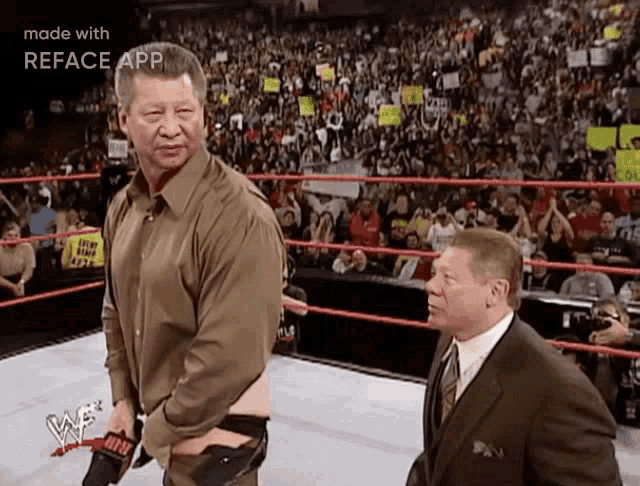 two men are standing in a wrestling ring with the word reface on the bottom left