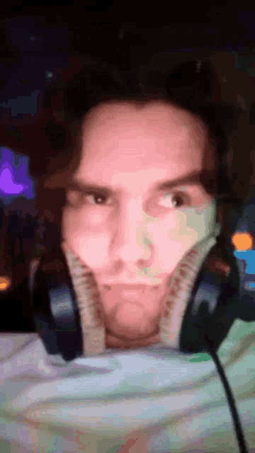 a man wearing headphones has his mouth open