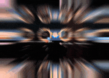 a blurry picture of a person 's face with the letter m in the center