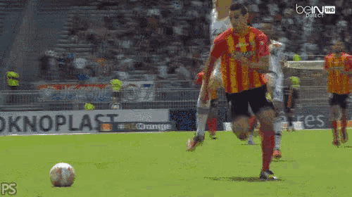 a group of soccer players are playing on a field with bein sports in the background