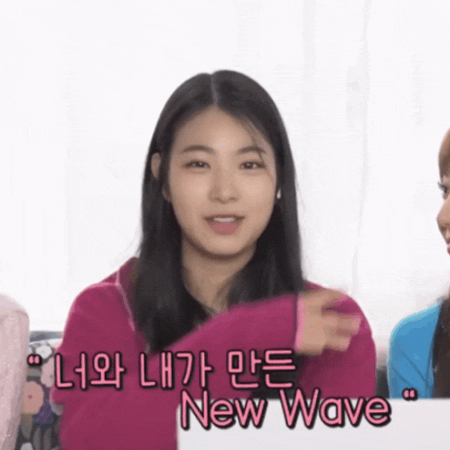 a girl in a pink sweater says new wave in a foreign language