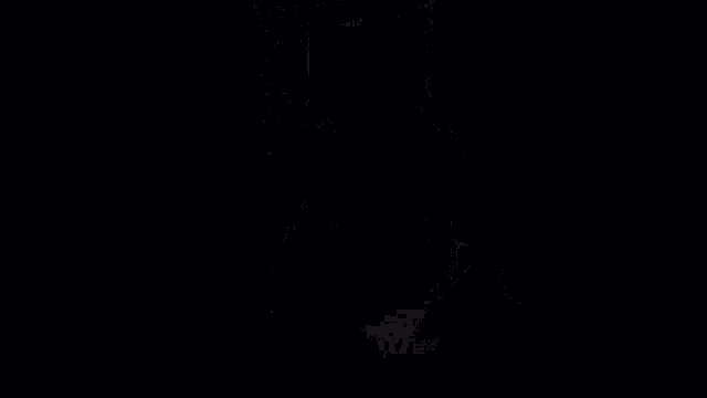 a man is sitting in a chair in a dark room wearing a blue teamview jersey .