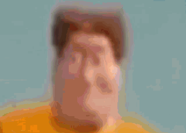 a man in a blue shirt is smiling and has a triangle cut out of his face