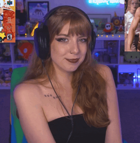 a woman wearing headphones is smiling in front of a nintendo game