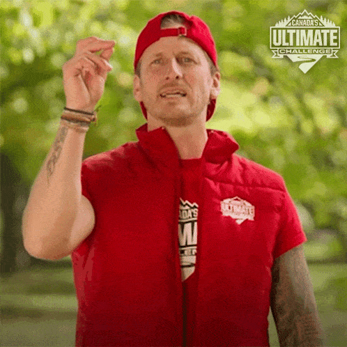 a man wearing a red vest that says ultimate on it