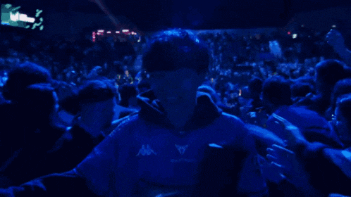 a man in a kappa shirt is surrounded by a crowd of people