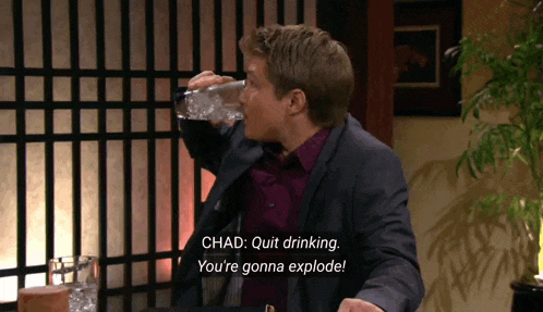 a man in a suit is drinking from a bottle and says chad quit drinking