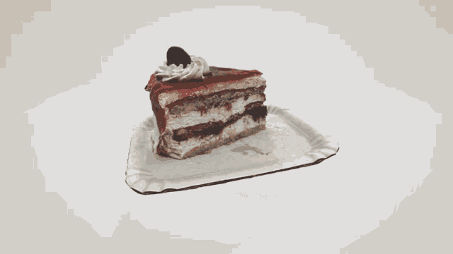 a slice of cake on a paper plate on a table