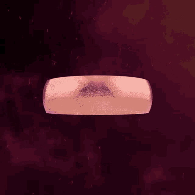a purple ring with a hole in the middle is floating in the air .