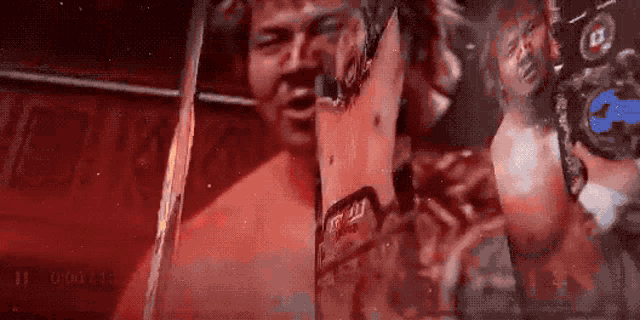 a man in a boxing ring is holding a sign that says ' i 'm a champion ' on it