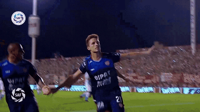 a soccer player with the number 21 on his jersey is celebrating