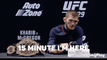 a man sitting in front of a sign that says ufc