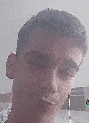 a close up of a young man 's face with headphones on .