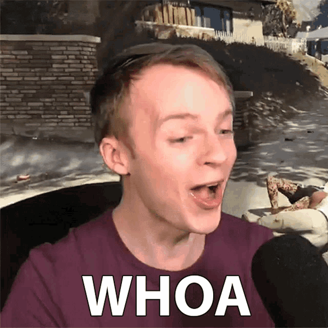 a man in a purple shirt with the word whoa on his chest