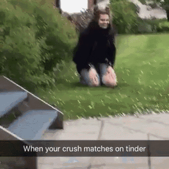 a woman is kneeling down in the grass with a caption that says " when your crush matches on tinder "