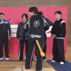 a man in a black jacket with the number 6 on the back
