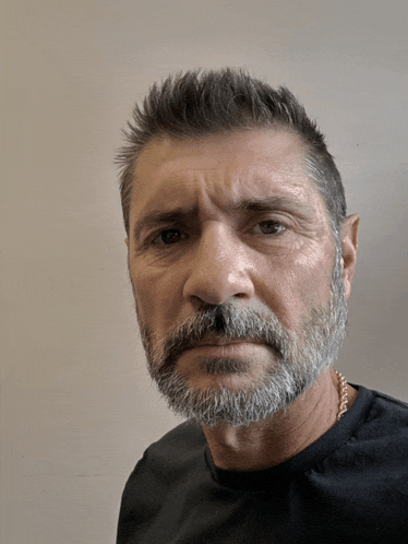 a man with a beard wearing a black shirt