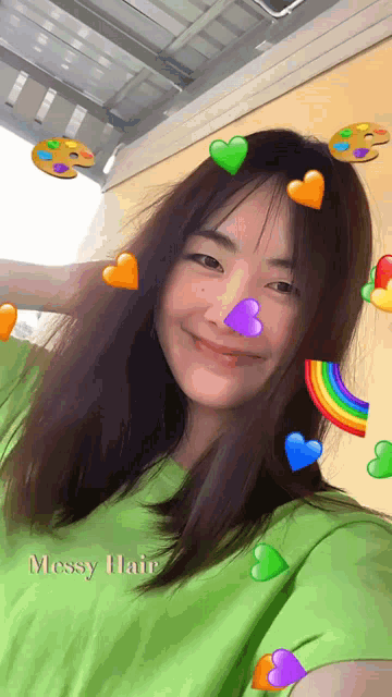 a girl wearing a green shirt with messy hair on it