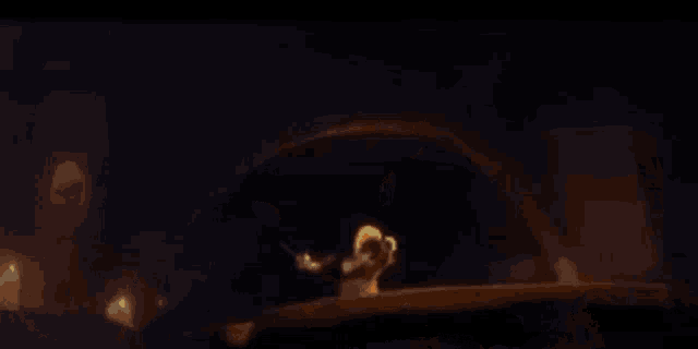 a close up of a cat 's face in a dark room with a blurred background .