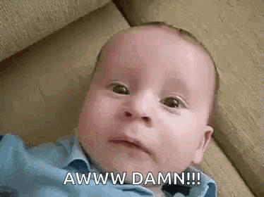 a baby is laying on a couch and making a funny face while saying awww damn !