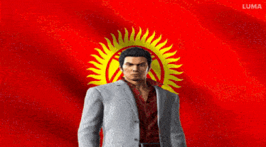 a man in a suit holds his fist in front of a red and yellow flag