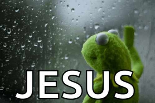 kermit the frog is standing in front of a window with the word jesus written on it