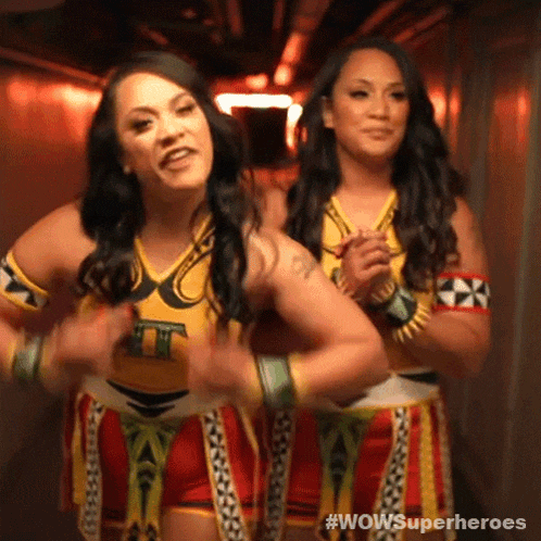 two women are standing next to each other in a hallway with the words wowsuperheroes on the bottom