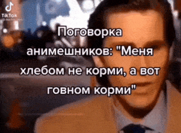 a man in a suit and tie is talking in a foreign language while wearing headphones .