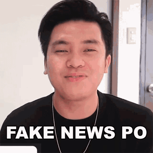 a man in a black shirt is smiling and says fake news po .