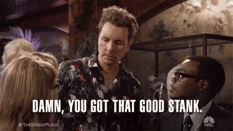 a man in a floral shirt is talking to a group of people and says `` damn , you got that good stank ''