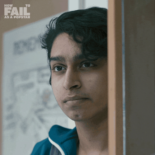 a poster for how to fail as a popstar shows a young man peeking out from behind a door