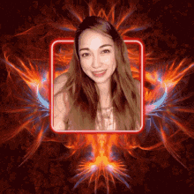 a woman 's face is surrounded by flames and fire