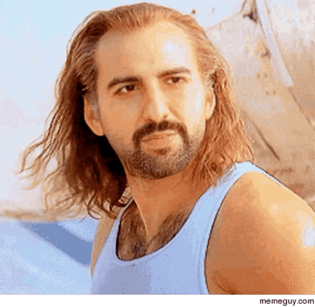 a man with long hair and a beard is wearing a tank top