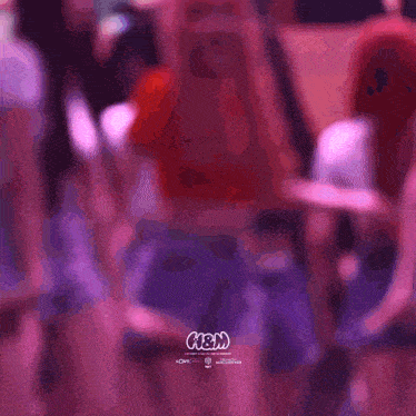 a blurry photo of a group of people with the word n & m on the bottom right