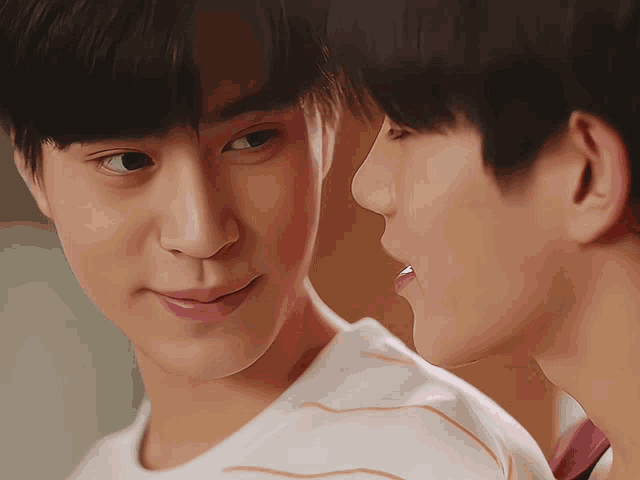 two young men are looking at each other and one has his tongue hanging out