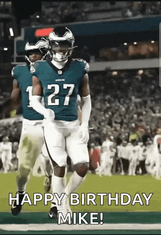 a group of football players are running on a field with the caption `` happy birthday mike '' .