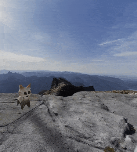 a cartoon character is standing on top of a rocky cliff with mountains in the background
