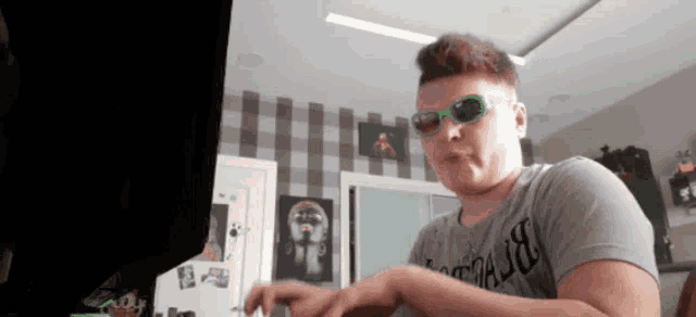 a man wearing sunglasses and a shirt that says ' abercrombie ' on it