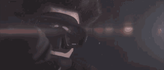 a close up of a person wearing headphones and a helmet
