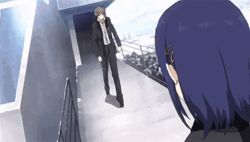a man and a woman are standing next to each other in a hallway .