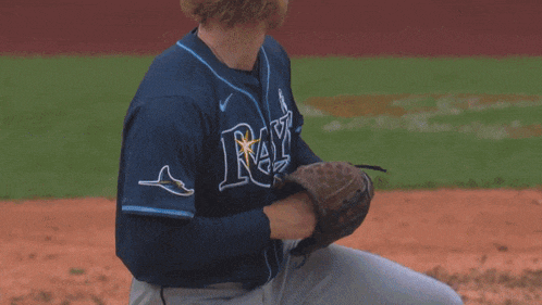 a mets player swings his bat at a ball