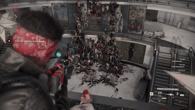 a man in a red bandana is holding a gun in front of a crowd of zombies in a video game