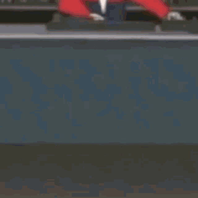 a girl in a red skirt and hat is dancing in a room .