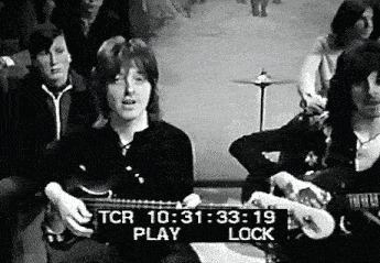 a black and white photo of a man playing a guitar with a sign that says tcr play lock