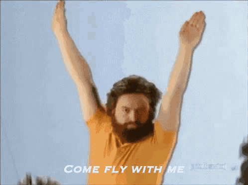 a man with a beard is flying through the air with his arms outstretched and says come fly with me